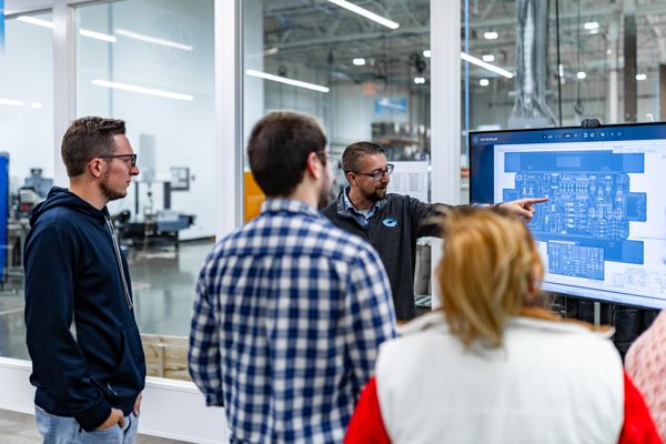 Expert team of engineers collaborating on design for manufacturability